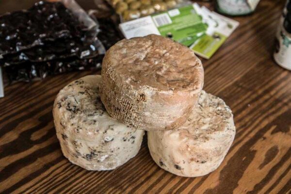 Balls of thilikotiri Naxos cheeses on wooden surface